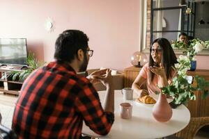 content Indien couple ayant petit déjeuner et petit parler ensemble dans le cuisine - amitié, sortir ensemble et famille photo