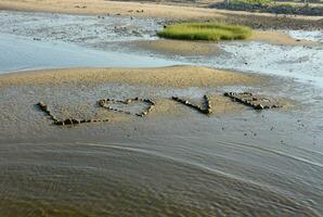 l'amour signe fabriqué de rochers sur une le sable plage photo