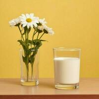 deux verre de Lait avec fleur sur une en bois table dans une Jaune arrière-plan, nutritif et en bonne santé laitier des produits concept photo