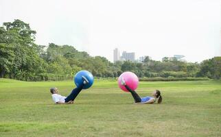 Sénior homme et le sien fille est prendre plaisir Faire exercice avec Gym Balle dans vert nature, concept pour personnes âgées gens activité, famille relation photo