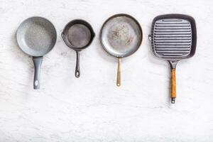 Haut de vue quatre des casseroles sur une marbre table photo