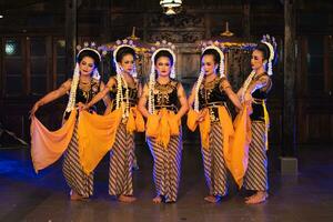 une groupe de Javanais danseurs en portant Jaune châles tandis que dansant sur étape photo