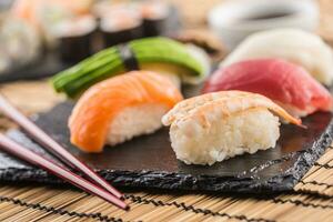 ensemble de Nigiri Sushi sur ardoise planche avec baguettes photo