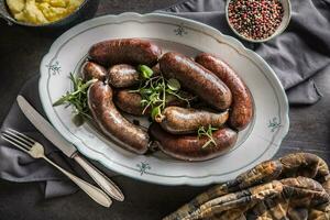 rôti saucisses dans la poêle avec Romarin. traditionnel européen nourriture bratwurst jaternice ou jirnice photo