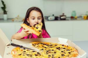 peu fille avec gros Pizza à Accueil photo