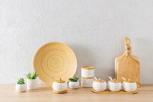 une ensemble de blanc céramique espace de rangement pots et en bois Coupe planches dans le intérieur de un respectueux de la nature cuisine. minimalisme. éco articles. photo