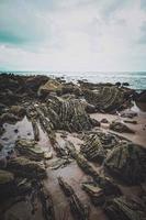 rochers sur la plage de la côte à bilbao en espagne photo