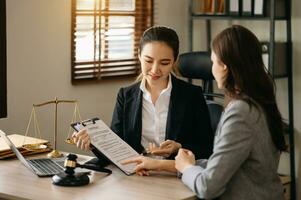 affaires et avocat ou conseiller consultant et discuter Contrat papiers avec portable et tablette à loi raffermir dans bureau. photo