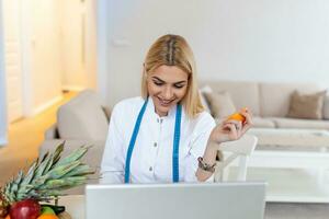 nutritionniste souriante dans son bureau, elle montre des légumes et des fruits sains, des soins de santé et un concept de régime. nutritionniste féminine avec des fruits travaillant à son bureau. photo