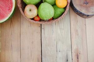 panier de pommes, des oranges, goyave et pastèque sur une en bois tableau, Stock photo