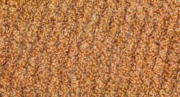 tricoté la laine textile avec Contexte texture dans lumière beige crémeux marron ombre. beige Couleur pente sur texture Contexte. foulard. photo