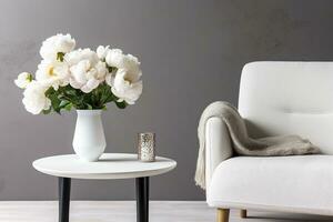 vase de blanc pivoines avec café table et fauteuil près gris mur. génératif ai photo