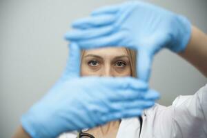médecins mains dans médical gants dans le forme de une carré avec copie espace photo