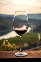 fermer de verre de rouge du vin reflétant vignoble paysage offre serein ambiance ai génératif photo