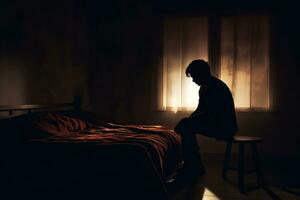 silhouette déprimé homme Malheureusement séance sur le lit dans le chambre à coucher. triste asiatique homme Souffrance la dépression insomnie éveillé et asseoir seul sur le lit dans chambre à coucher. établi avec génératif ai. photo