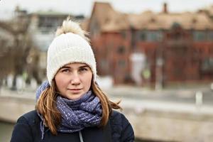 portrait d'une jeune belle fille souriante heureuse sur le fond de la ville. mode d'hiver, concept de vacances de Noël. photo