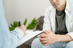 homme avec mental santé problèmes est consultant. psychiatre est enregistrement le les patients état pour traitement. encouragement, l'amour et famille problème, bipolaire , la dépression patient, protéger suicide photo