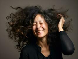 50 année vieux asiatique femme dans émotif dynamique pose sur solide Contexte ai génératif photo