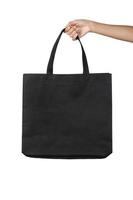 Hand holding tote bag isolé sur fond blanc photo