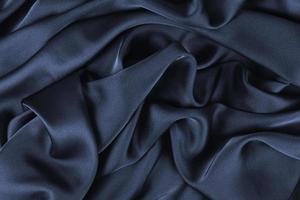 tissu de fond. tissu textile foncé avec une texture et un fond de draperie à motifs photo