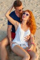 Jeune couple dans l'amour content sur été plage ensemble ayant amusement photo