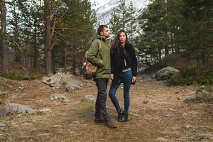 Jeune magnifique branché couple randonnée dans montagnes photo