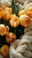Frais tulipes et une tricoté chandail arrangé dans une branché plat allonger verticale mobile fond d'écran ai généré photo