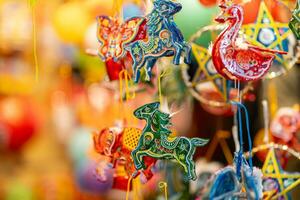 décoré coloré lanternes pendaison sur une supporter dans le des rues dans ho chi minh ville, vietnam pendant milieu l'automne festival. chinois Langue dans Photos signifier argent et Bonheur. sélectif se concentrer.