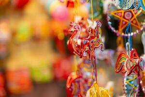 décoré coloré lanternes pendaison sur une supporter dans le des rues dans ho chi minh ville, vietnam pendant milieu l'automne festival. chinois Langue dans Photos signifier argent et bonheur