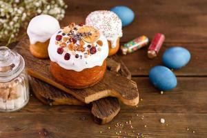 gâteaux de fête avec glaçage blanc, noix et raisins secs avec œufs de pâques sur la table de fête photo