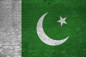 Pakistan drapeau représenté dans peindre couleurs sur vieux brique mur. texturé bannière sur gros brique mur maçonnerie Contexte photo