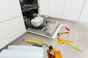 Accueil Lave-vaisselle appareil étant réparé dans une cuisine photo