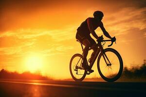 une homme équitation une vélo sur une route à le coucher du soleil photo