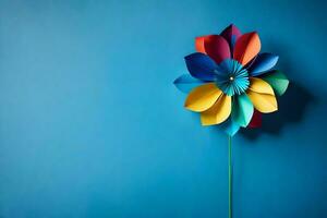 une coloré papier fleur sur une bleu mur. généré par ai photo