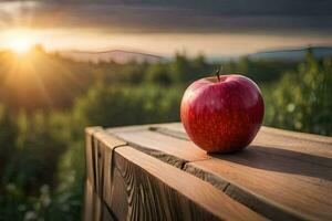 un Pomme est assis sur une en bois table dans de face de une le coucher du soleil. généré par ai photo