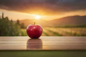 un Pomme est assis sur une table dans de face de une le coucher du soleil. généré par ai photo