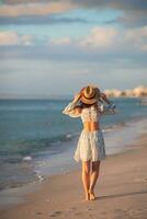 jeune femme heureuse sur la plage profite de ses vacances d'été photo