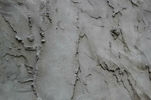 inégal ciment et le sable mur texture arrière-plan, grungy ciment mur surface, rustique le sable mur photo