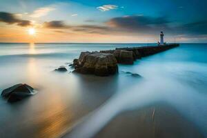 une phare dans le océan à le coucher du soleil. généré par ai photo