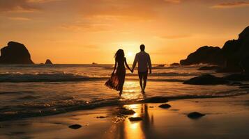 couple en marchant main dans la main sur une plage à le coucher du soleil photo