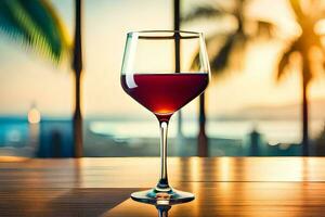 une verre de rouge du vin sur une table dans de face de le le coucher du soleil. généré par ai photo