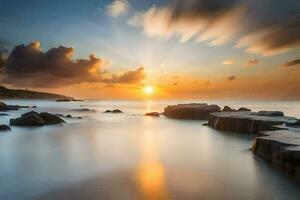 une magnifique le coucher du soleil plus de le océan avec rochers et l'eau. généré par ai photo