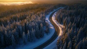 aérien vue de courbée venteux route dans neige couvert forêt. génératif ai photo