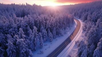 aérien vue de courbée venteux route dans neige couvert forêt. génératif ai photo