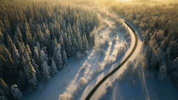 aérien vue de venteux et courbée route dans neige couvert forêt paysage. génératif ai photo