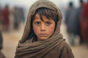 une pauvres regarder faim orphelin garçon dans une réfugié camp avec une triste expression sur le sien visage et le sien visage et vêtements sont sale et le sien yeux sont plein de douleur. génératif ai photo