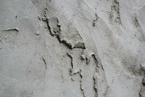 inégal ciment et le sable mur texture arrière-plan, grungy ciment mur surface, rustique le sable mur photo