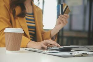 femmes en portant crédit carte et en utilisant les smartphones à maison.en ligne achats, l'Internet bancaire, boutique en ligne, paiement, dépenses argent, commerce électronique Paiement à le magasin, crédit carte, concept photo