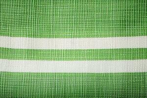 vert et blanc rayé en tissu texture Contexte. ai généré photo
