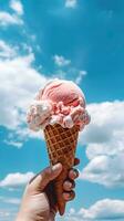 main en portant fraise la glace crème avec cône isolé sur une bleu ciel et nuage Contexte. ai généré photo